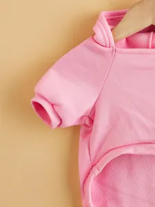 Pink fleece pet hoodie detail shot, warm dog sweatshirt with cute hooded design for autumn.