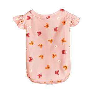 Detailed view of pink summer pet dog vest featuring cute cartoon animal and flower print pattern.