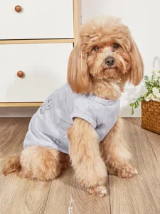 Detail view of a grey pet tank top with cute animal embroidery, worn by a small dog.