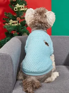 Close-up view of the cozy coral fleece pet sweater in light blue with cute dog embroidery detail.