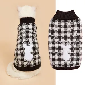 Close-up detail of black white plaid pet sweater with cute deer patch and warm collar.