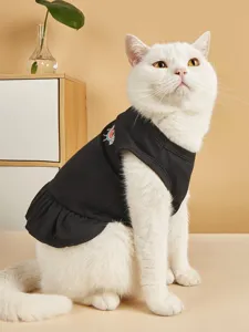Detailed view of a cute black pet dress with watermelon embroidery, worn by a lovely white cat.