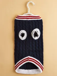 Detailed view of the dark blue cable knit pet sweater with red and white striped trims.