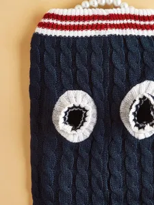 Detailed view of blue cable knit pet sweater with pearl trim, retro striped design for pets.