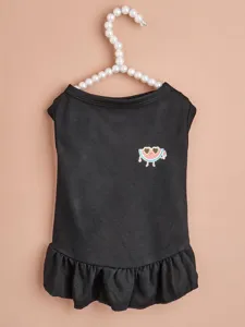 Detailed view of black pet dress with cute watermelon print and ruffled hem for cats dogs.