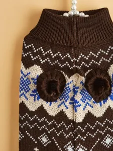 Detail of brown pet knitted sweater with snowflake pattern, warm medium-high collar for dogs.