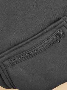Close-up detail of black pet hoodie zipper pocket showing fine fabric texture and hardware.