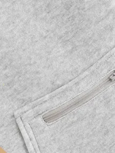 Detailed view of the gray pet hoodie fabric and zipper pocket, showing fine stitching.