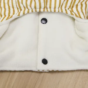 Pet clothing detail view showcasing yellow striped collar and soft fleece lining buttons.