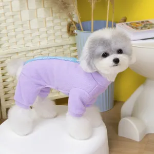 Cute winter pet fleece jumpsuit detail shot, showing soft warm purple dog clothes on a stool.