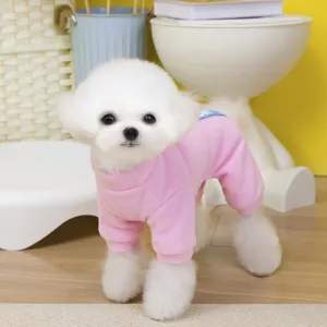 Detailed view of a cute fluffy dog wearing a cozy pink fleece pet jumpsuit, soft and warm.