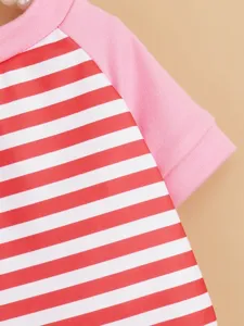 Close-up detail of pet dog t-shirt with pink raglan sleeves and red white stripe pattern.