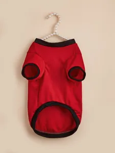 Detailed view of the red pet dog t-shirt with black trim, showing fabric and two-legged cut.