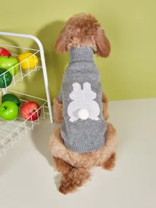 Close-up view of a cozy grey dog sweater featuring a cute knit bunny and fluffy tail pom-pom.