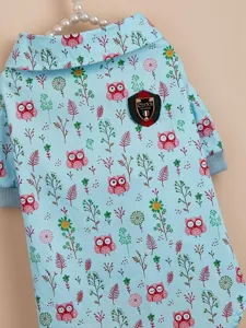 Close up detail view of cute light blue pet sweater featuring owl and floral print design.