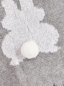 Close-up of grey knitted pet sweater featuring a cute white rabbit pattern and fluffy pom-pom tail detail.