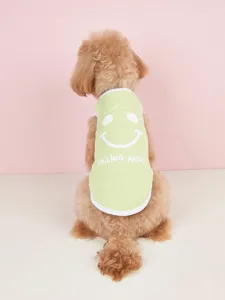 Detail view of a cute spring summer dog vest in solid green featuring a fun smiley face graphic.