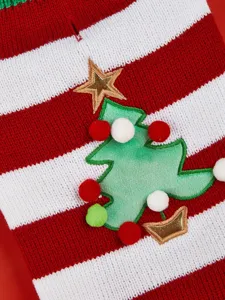 Detailed shot of pet Christmas sweater, red white stripe knit with cute tree and pom-pom decor.