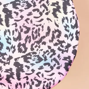 Close-up detail of colorful gradient leopard print pet fleece fabric, soft texture.