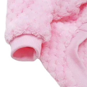 Close up detail of soft pink fleece pet clothes showing warm ribbed cuff and fluffy fabric texture.