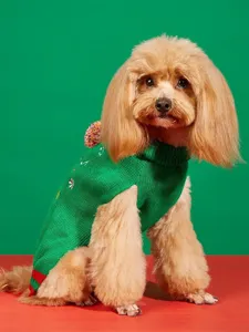 Detailed view of Christmas green knitted pet sweater with pom-pom for dogs and cats.