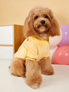 Detailed shot of a pet wearing a soft yellow fleece sweater, warm and cozy winter pet clothing.