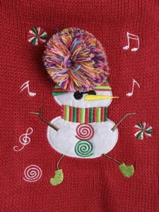Close-up detail of the cute Christmas snowman embroidery and colorful pompom on red knit sweater.