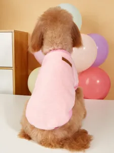 Cute pink fleece pet vest detail showing soft fabric and classic leather label for small dogs.