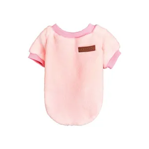Detailed view of the soft pink pet fleece sweater with cozy lining and classic leather badge.