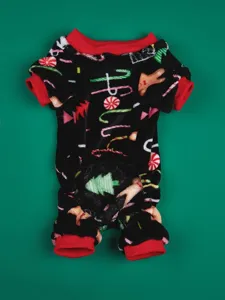 Detailed view of soft black fleece dog pajamas with cute Christmas prints and red trim.