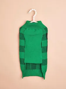 Detailed view of a stylish green and black checkered knit pet sweater hanging on a pearl hanger.