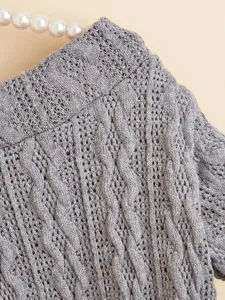 Grey knit pet sweater close-up, textured vertical stripe design for small dogs like puppies.