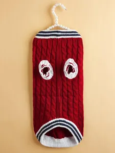Detailed view of the red cable-knit pet sweater with white and navy striped trim.