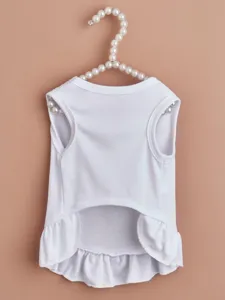 Detailed view of a plain white pet dress with a cute ruffled hem for dogs and cats.