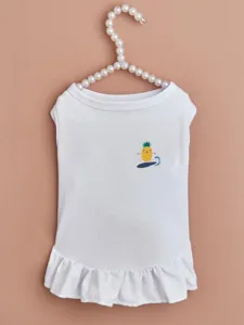 White pet dress detail showing soft cotton fabric, ruffled hem, and cute pineapple print.