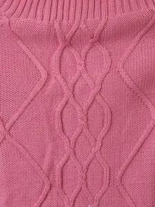 Pink cable knit pet sweater fabric texture close up view showing soft diamond pattern design.