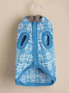 Blue knit dog sweater with white snowflake pattern and cozy faux fur collar detail winter wear.