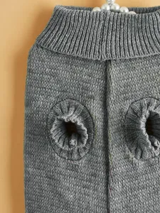Grey dog sweater detail, soft knit pet apparel texture, cozy winter pet clothing close-up.