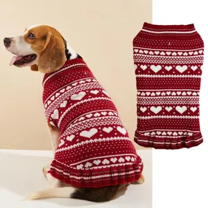Detailed view of cute red and white knit pet sweater with heart patterns and lovely ruffled hem.