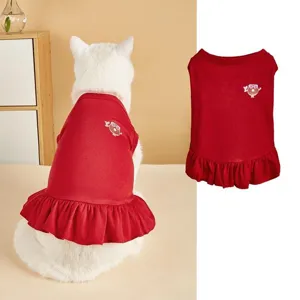 Red pet dress detail showing cute donut embroidery and ruffled hem for cats and small dogs.