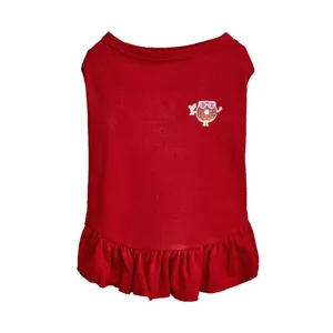 Red pet dog dress detail featuring cute donut print and stylish ruffled hem design.