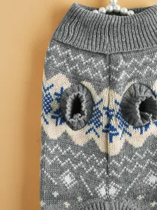 Close-up detail of grey knitted pet sweater with classic Nordic snowflake and wave pattern.