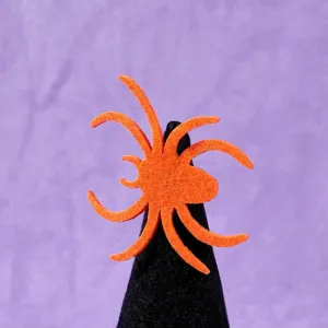 Orange felt spider detail shot for Halloween pet costume accessories decoration close-up view.