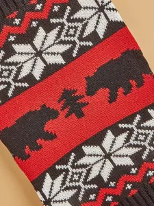 Close-up detail of winter Christmas knitted pet sweater with Nordic snowflake and bear pattern.