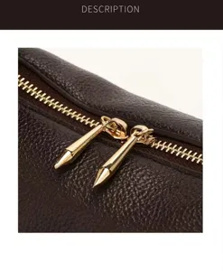 Detailed view of brown leather shoulder bag with chic metal zipper and cone pulls.