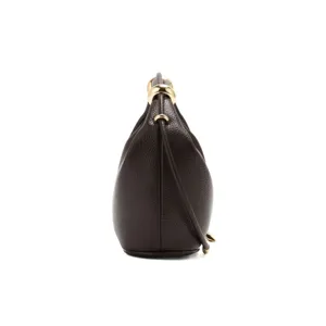 Detailed side view of the dark brown leather shoulder dumpling bag showing gold hardware rings.