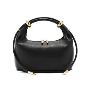 Black leather dumpling handbag with chic gold hardware, minimalist style, detail view.