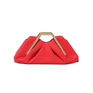 Detail shot of red pleated clutch bag with golden rigid metal geometric top handle.