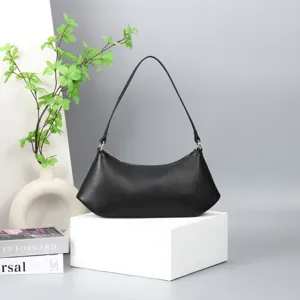 Detailed view of the stylish black underarm shoulder bag with clean lines and gold hardware.