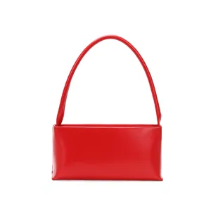 Red leather baguette underarm bag detail, minimalist chic single shoulder handbag strap view.